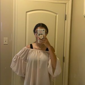 its a off the shoulder , light , flowy , blouse .